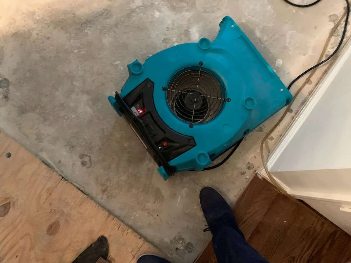 Air mover drying subfloor during Commercial Water Damage Restoration in Cudahy